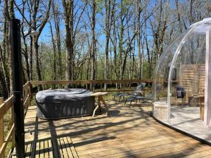 a wooden deck with a gazebo and a mattress at Bulle de Morphée & Spa in Escamps
