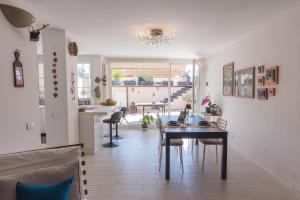 a kitchen and dining room with a table and chairs at Casa Gaia, Piombino in Piombino