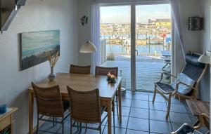 a dining room with a table and a view of a marina at Bønnerup Strand in Glesborg