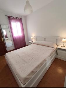 a bedroom with a white bed and a window at El bosque NOMADA II in El Bosque
