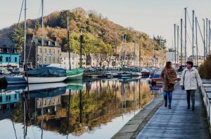 two people walking along a dock near a marina at Entre terre & Mer in Saint-Brieuc +9 photos