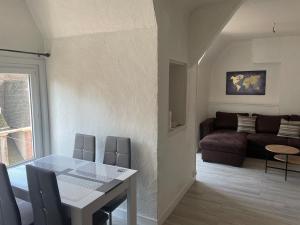 a living room with a table and a couch at Le Gambetta in Gien