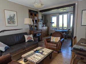 a living room with a couch and a table at NIGHT & DAY in Honfleur