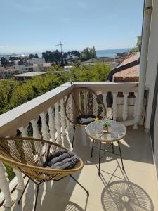 a balcony with two chairs and a table at Becic Apartments in Ulcinj