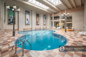 a large swimming pool in a large room with a building at 203A Efficiency One Bath in Oakland
