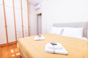 a bedroom with a large bed with towels on it at Mouragia Budget Places in Corfu Town