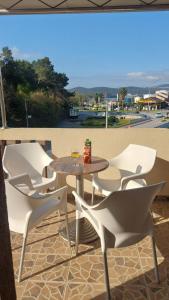 a table and chairs sitting on a patio at Apartments Ivo Bozinovic in Tivat