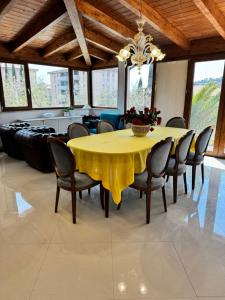 a dining room with a yellow table and chairs at Villa Graziella Perugia in Perugia +74 photos