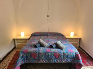 a bedroom with a bed with two lamps on it at CASA BACICCIA in Badalucco