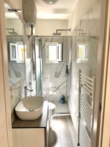a white bathroom with a sink and a toilet at Accommodation near the airport in Florence +26 photos