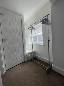 an empty room with a door and a treadmill at Cartway Apartment in Bridgnorth +5 photos