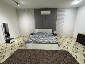 a bedroom with a bed and a flat screen tv at AlZaeem Resort & Hotels in Barka +24 photos