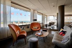 a living room with a view of the ocean at Saint Aubin Logis Hôtel & Restaurant in Saint-Aubin-sur-Mer