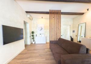 a living room with a couch and a large television at Pantheon Urbes Collection in Rome