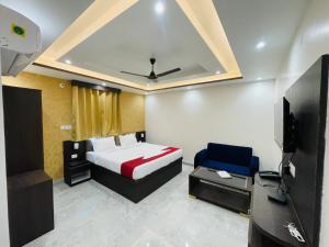 a hotel room with a bed and a tv at Hotel D B Palace in Patna