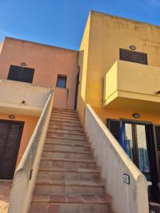 a stairway leading up to a building with a building at La casetta di Glenda in Favignana