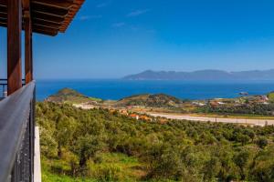 a view of the ocean from a house at Petralia's Apartment in Skiathos National Airport