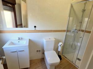 a bathroom with a toilet and a sink and a shower at Vivienda Camino de San Martin in Frómista +12 photos