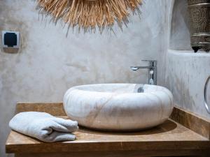 a bathroom with a large white tub on a table at Dar LalaFadma-Pvt 1BR Studio-1min to Bahia Palace in Marrakech +15 photos