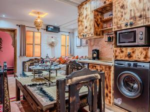 a kitchen and living room with a washer and dryer at Dar LalaFadma-Pvt 1BR Studio-1min to Bahia Palace in Marrakech