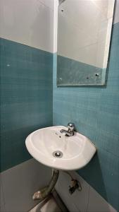 a bathroom with a sink and a mirror at Hotel VentureInn Nxe ITER Khandagiri - Airport - Lingaraj Temple in Bhubaneshwar