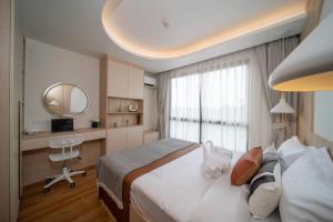 a bedroom with a bed and a desk and a mirror at now condo near beach 2bedroom in Kamala Beach +9 photos