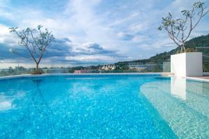 a large swimming pool with blue water at now condo near beach 2bedroom in Kamala Beach