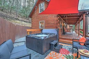 a wooden cabin with a hot tub and a grill at Luxury in the Smokey Mountains Pet Friendly with Hot Tub in Elizabethton