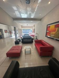 a lobby with couches and chairs in a building at Hotel Nuevo Enzo in Villa Carlos Paz +35 photos