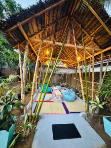 an outdoor room with a tent with a bunch of pillows at Moonlight surf hostel in Arugam Bay +20 photos