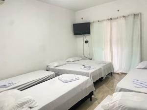 Postel nebo postele na pokoji v ubytování Pousada Sagrada Devoção
