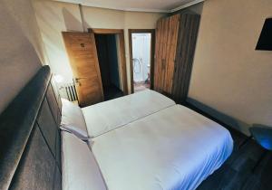 a bedroom with a white bed in a room at El Campillo in Cudillero
