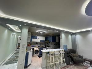 a kitchen with blue cabinets and a counter top at Al adl in Cairo