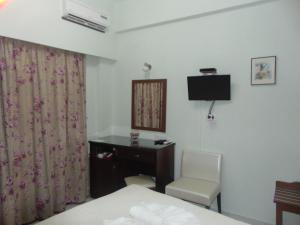 a room with a bed and a desk and a chair at Avra in Agia Galini