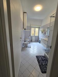 a bathroom with two toilets and two sinks at la casa di jo in Rome