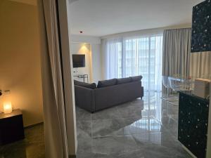 a living room with a couch and a glass table at Mercury Suites - Skydream Getaways in St. Julianʼs +229 photos