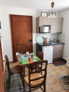 a kitchen and dining room with a table and chairs at Maison LES 3 ROSES in Wolfisheim +10 photos
