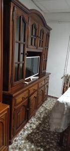 a large wooden entertainment center with a television on it at Apartamentos cañamares in Cañamares