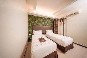 Postel nebo postele na pokoji v ubytování The Mesui Hotel Bukit Bintang