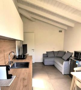 a kitchen and a living room with a couch at Colle Gelso in Cesena