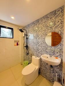 a bathroom with a toilet and a sink at VJB Homestay in El Nido