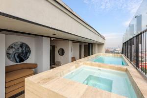 a swimming pool on the balcony of a house at Casa Colón by Wynwood House in Mexico City