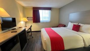 a hotel room with a bed and a desk at Rockview Hotel Castle Rock Downtown in Castle Rock +11 photos