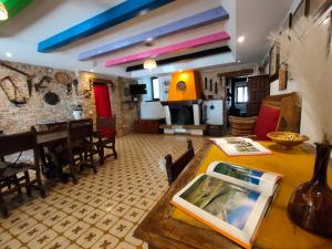 a living room with a table and a dining room at Villa per gruppi in Casa Santa Lucia
