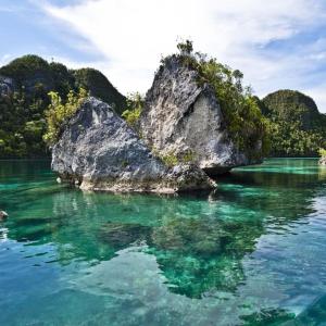 a large rock in the middle of a body of water at Beser Bay Homestay in Besir