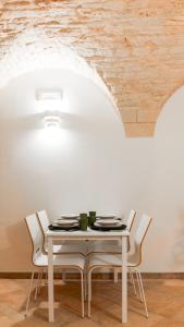 a white table and chairs in a room at Dimora Fiore Guest House in Martina Franca +8 photos