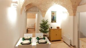 a kitchen with a table and chairs in a room at Dimora Fiore Guest House in Martina Franca