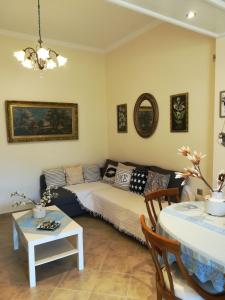 a living room with a bed and a table at Kerannymi Family Apartment in Vouniatádes