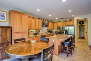 a kitchen with wooden cabinets and a wooden table at Indian Palms Vacation Villa Permit# 50273 in Indio