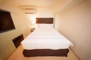 Postel nebo postele na pokoji v ubytování The Mesui Hotel Bukit Bintang